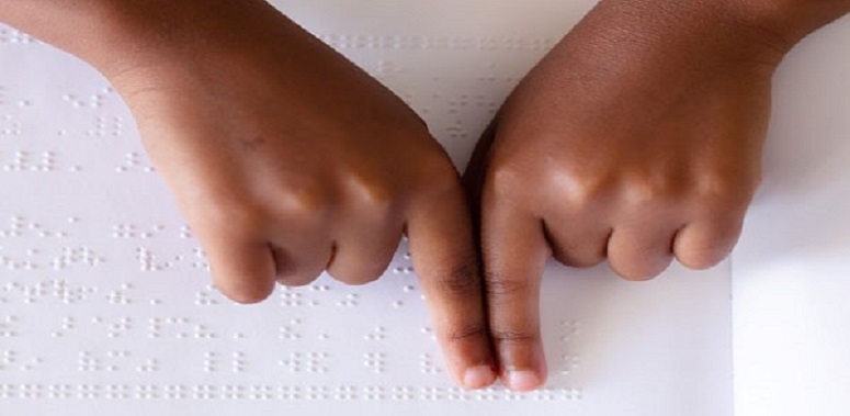 Hands reading Braille