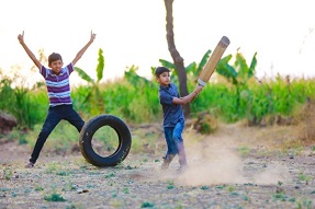 Boys playing cricket in India