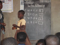 Child at blackboard Ghana CCE