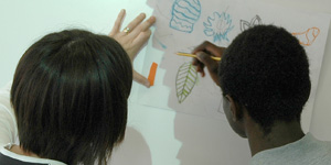 Students drawing at whiteboard