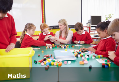 A teacher with students playing with maths cubes