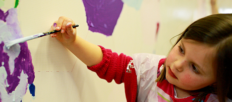 Nursery school girl painting