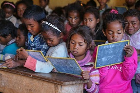 Children writing on small blackboards Madagascar
