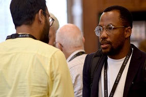 Daniel Hawkins Iddrisu chats to another delegate at 2023 UKFIET conference