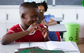 Boy doing sign language in classroom