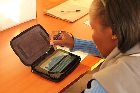 Girl uses an electronic tablet in class, Kenya