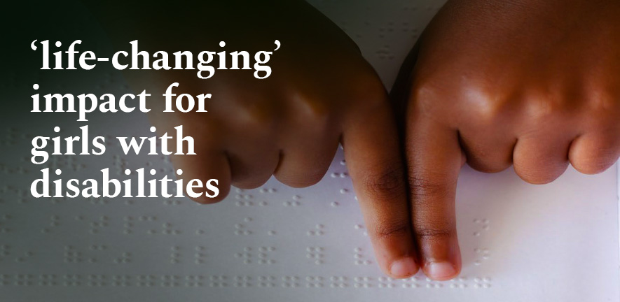 A child's hands reading braille