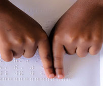 Hands pointing to Braille