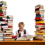 A boy surrounded by tall piles of books
