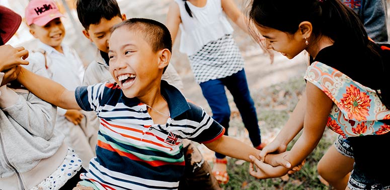 A group of children playing together and smiling