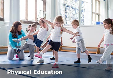 Children in a PE class balance on one leg, a teacher helps a pupil who is struggling