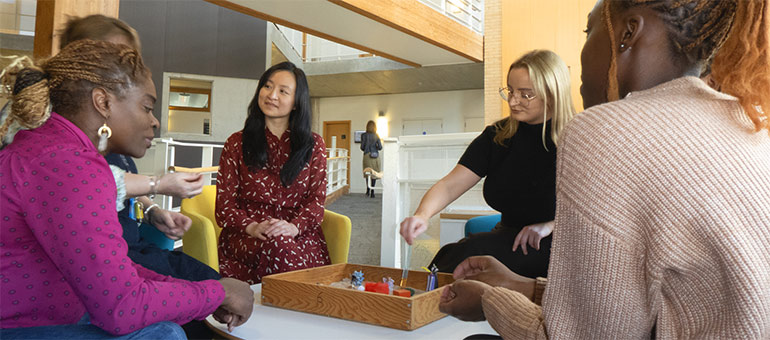 counselling people at table playing with a sandbox