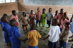 Primary school children singing in a circle, Rwanda