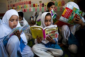 children reading on the floor of a classroom