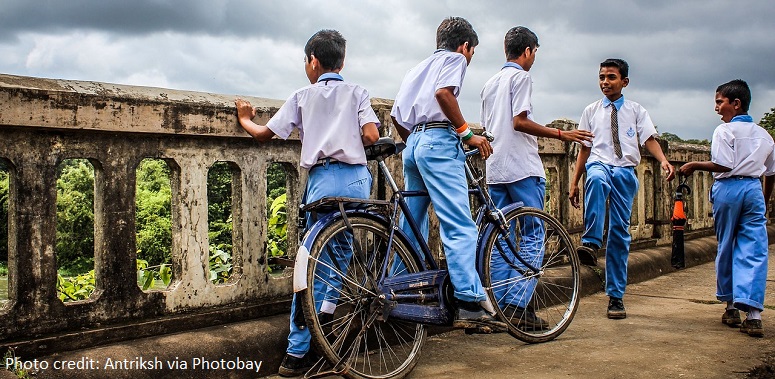 School children with a bicycle