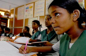 Deaf girl at her desk in the classroom
