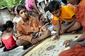Boys playing carrom, a popular board game in India