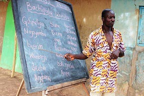 A teacher at an outdoor blackboard in northern Ghana