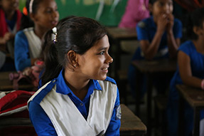A smiling student in class at Azimpur Government Primary School. Dhaka, Bangladesh