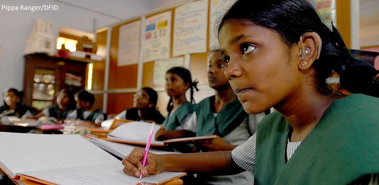 Deaf girl at her desk in the classroom