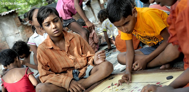 Boys playing carrom, a popular board game in India 