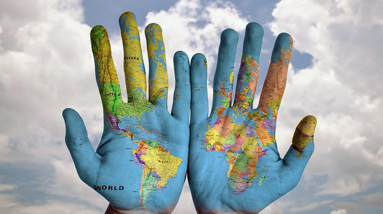 Image showing two hands with the world map found across their palms and centering the African, South and Central American continents.