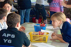 A group of primary school children working together at a table