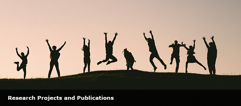 silloutted people with hands in the air on top of a grassy hill