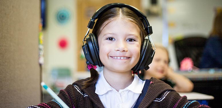 smiling girl wearing ear defenders