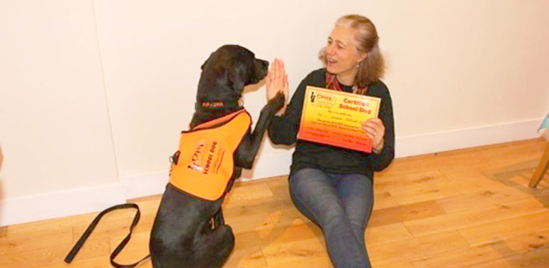 Deborah Neame high fiving her reading dog