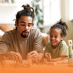 Imaginery play - A dad with building blocks,toy cars and figures plays on the floor with his child