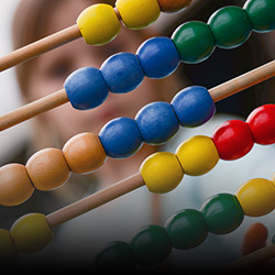 A school child works on an abacus