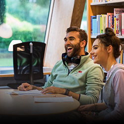 Two students pictured laughing and happy